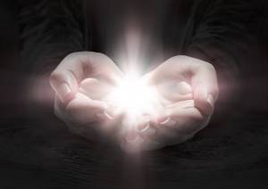 light in hands - pray the crucifix in darkness